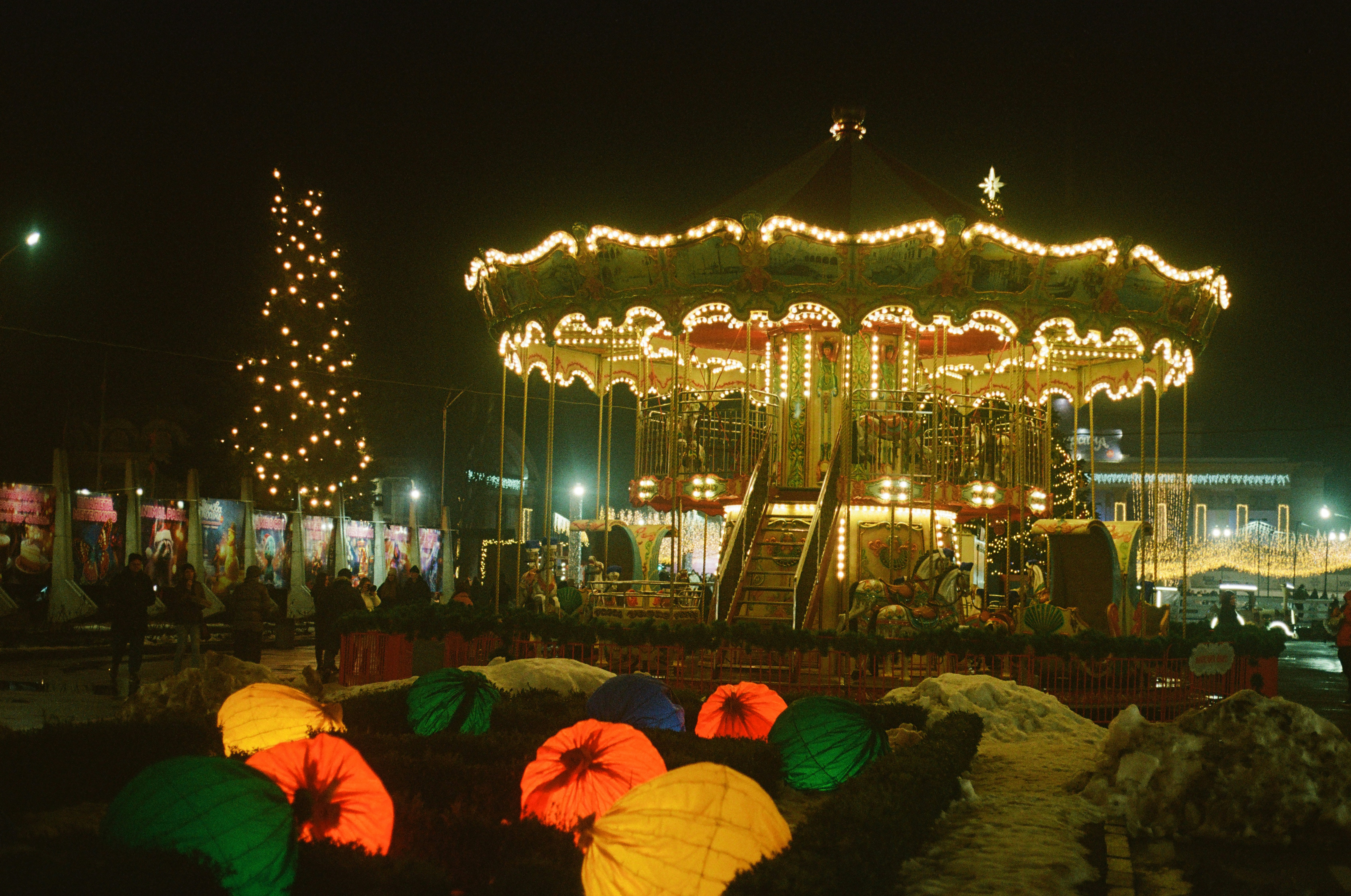 A merry go round at night with lights on