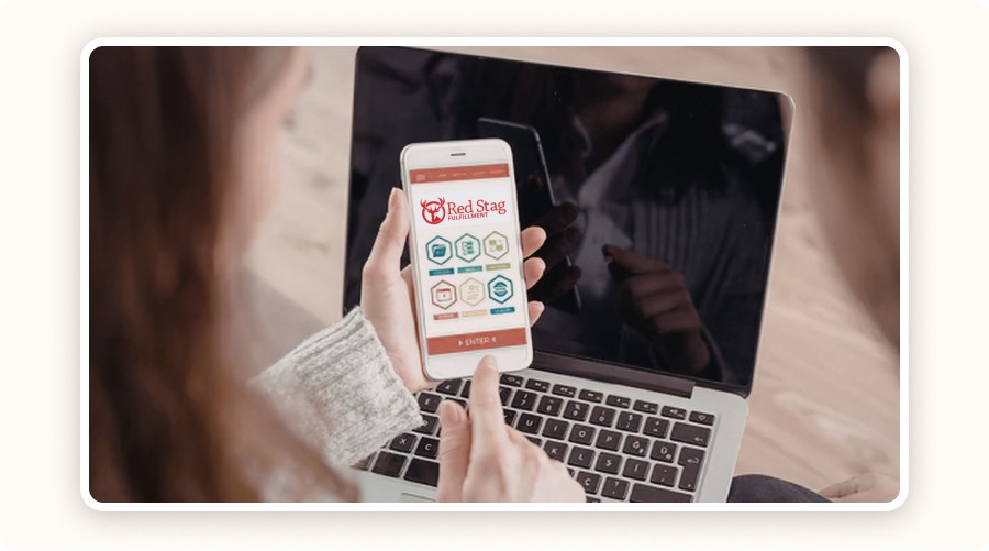 Person using smartphone showing Red Stag Fulfillment app interface