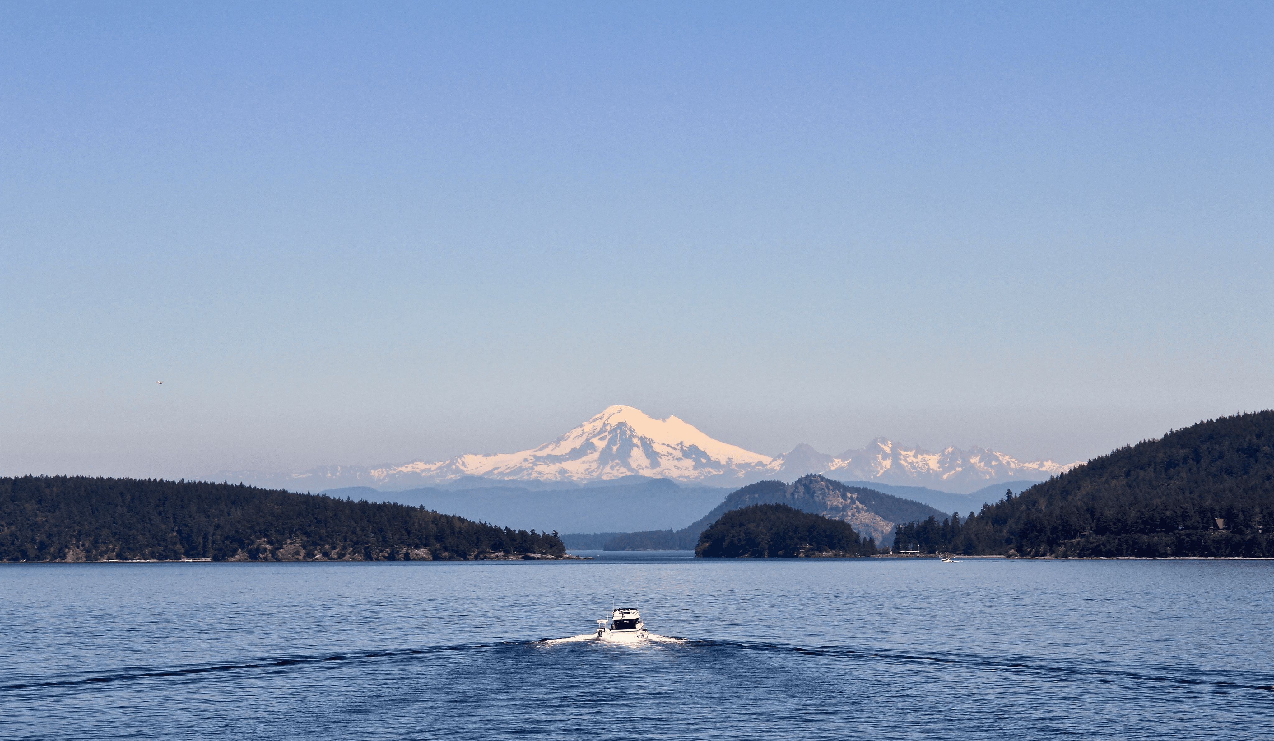 image of a boat sailing towards a mountain on Puget Sound