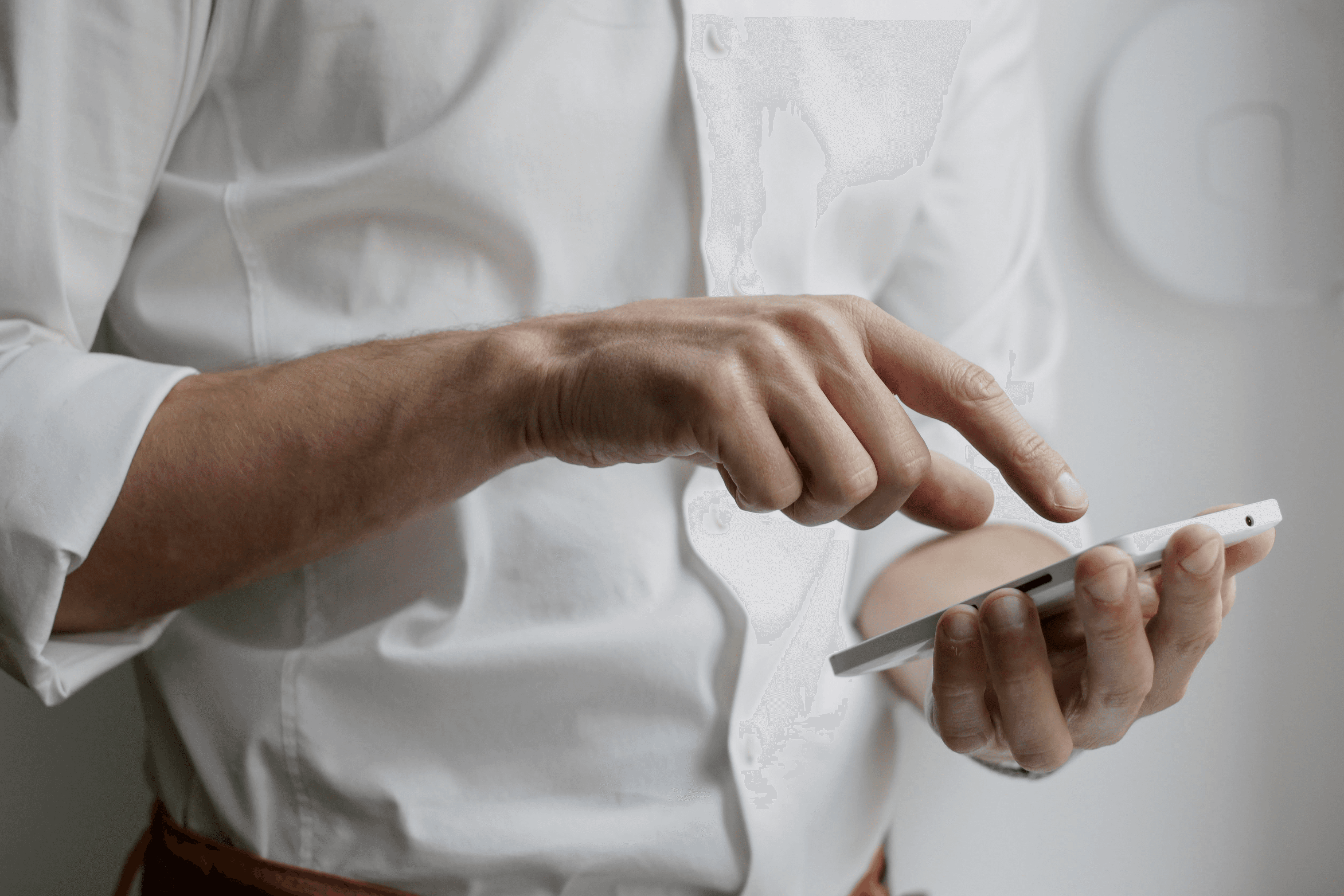 person holding white Android smartphone in white shirt