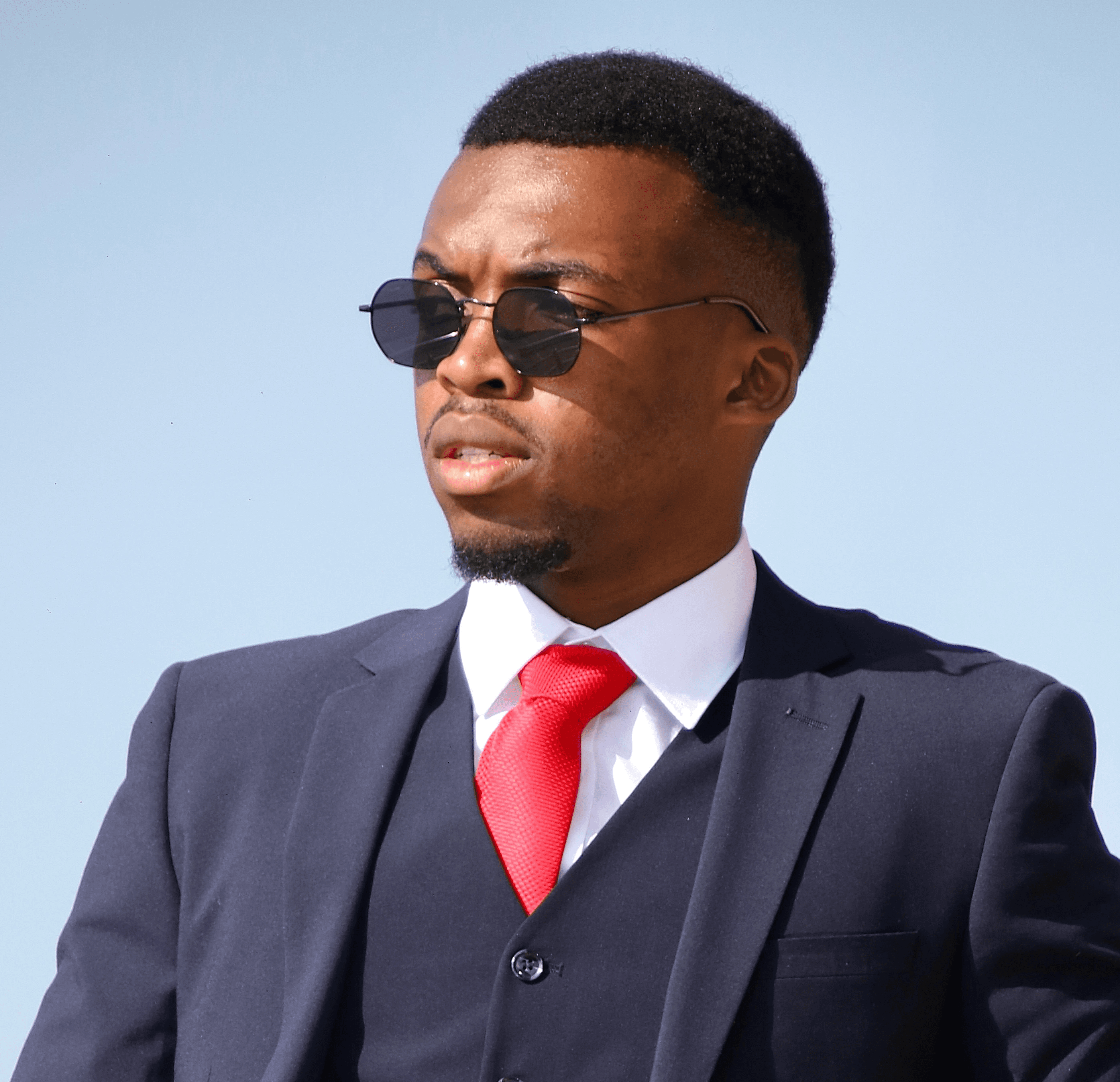 a man in a suit and red tie