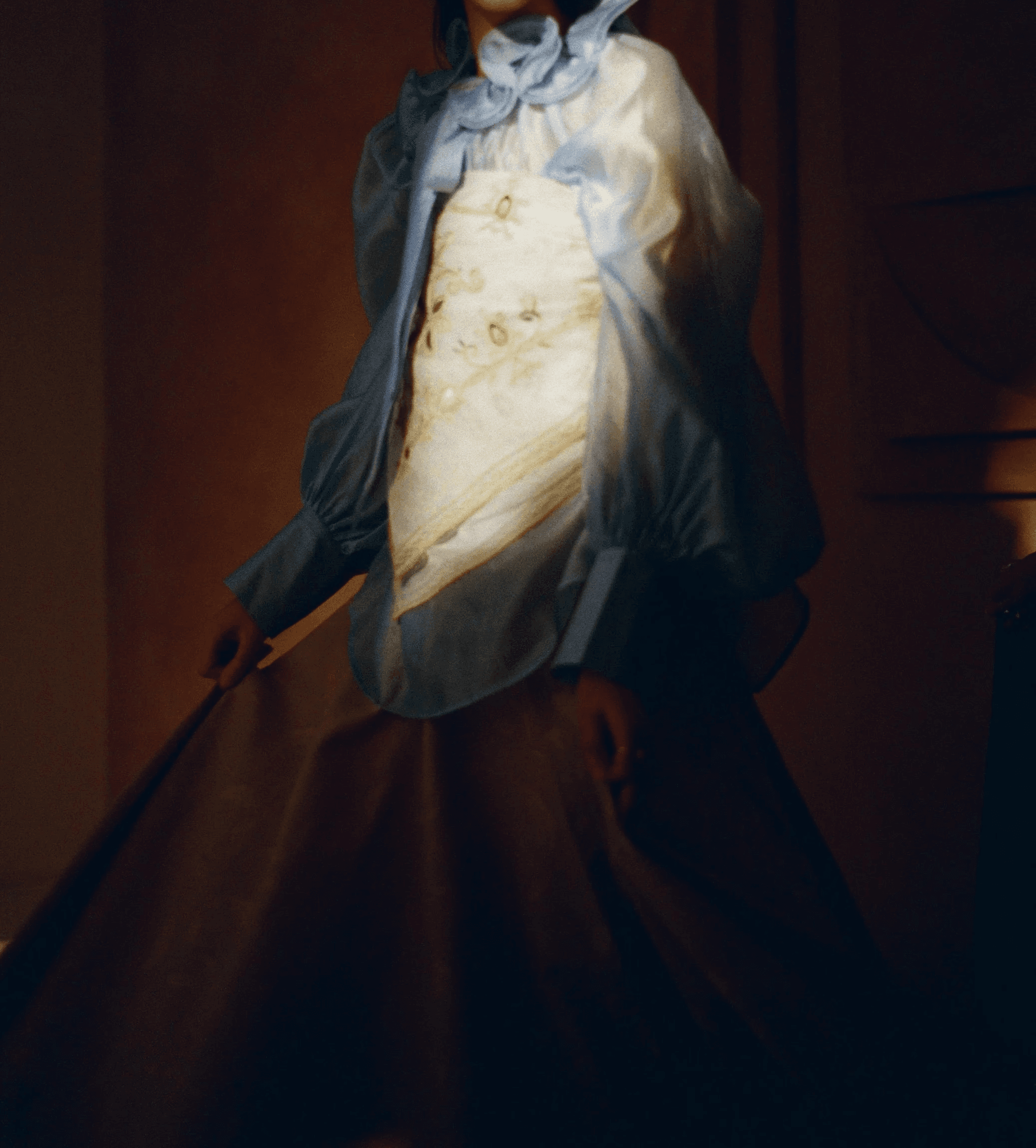 Tattooed pregnant woman in a net dress photographed in a warm studio for PERZIA.
