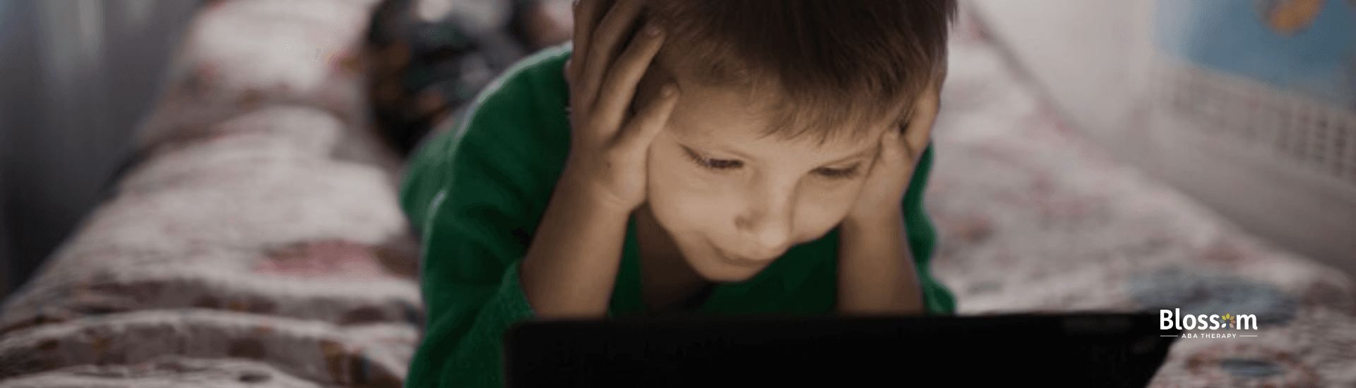 A boy watching from a mobile tablet