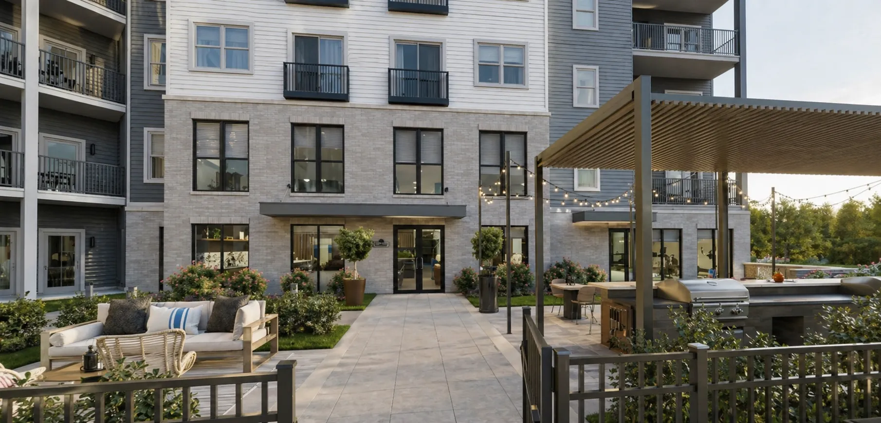 Outdoor patio area featuring seating and greenery at the new apartment complex, designed for relaxation and social gatherings.