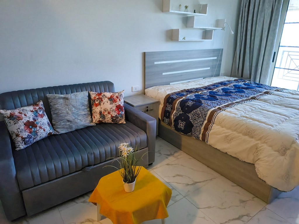 brown wooden house with green grass field