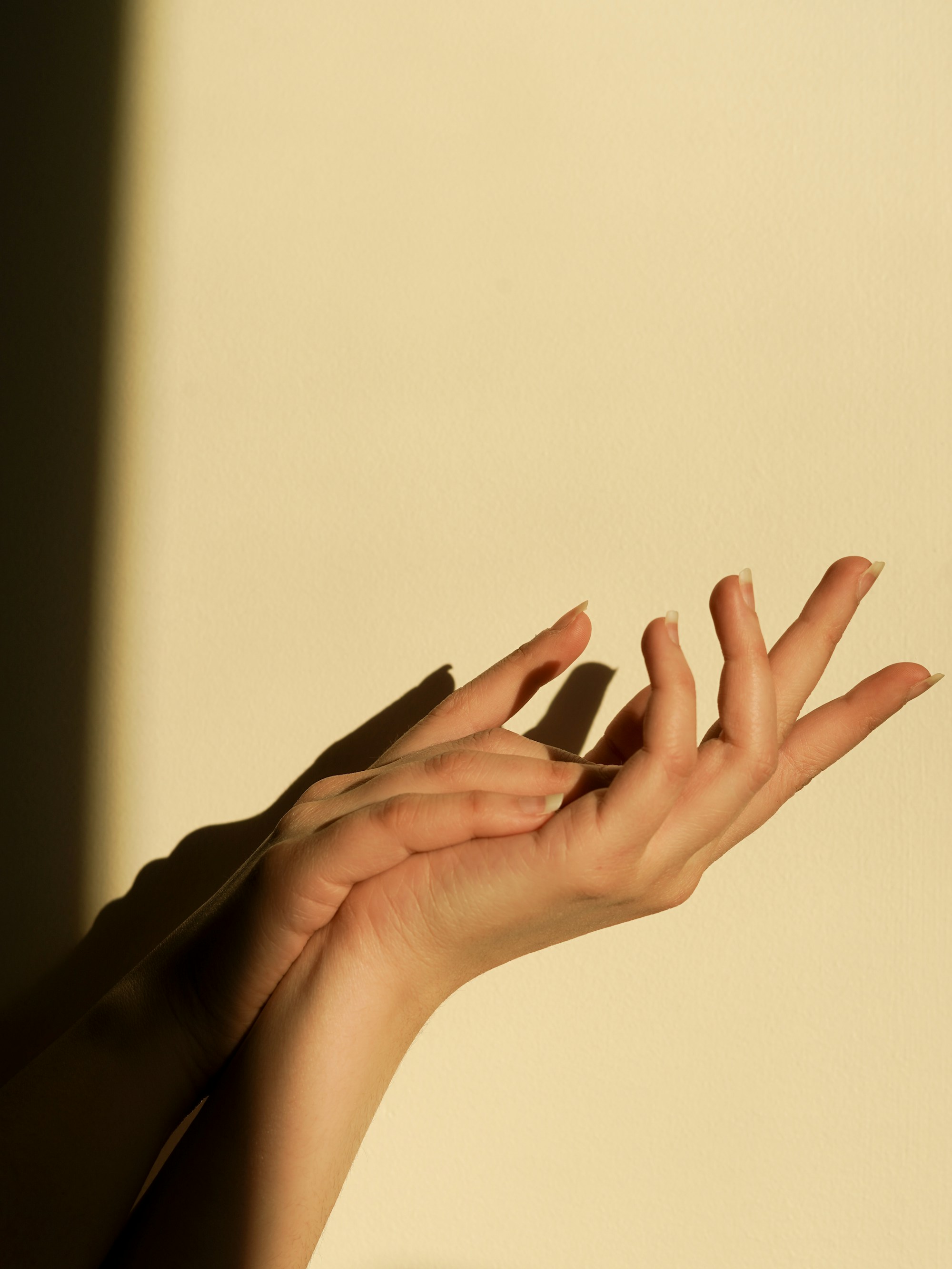 A hand resting on a white surface