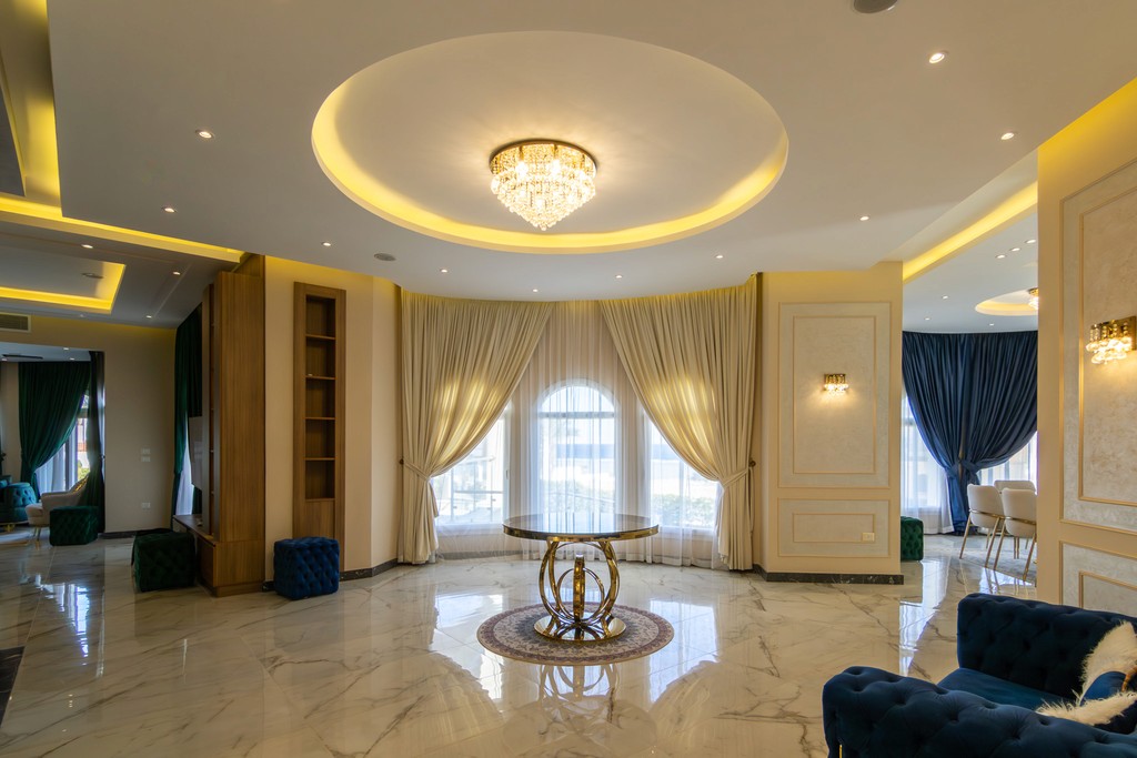 brown wooden house with green grass field