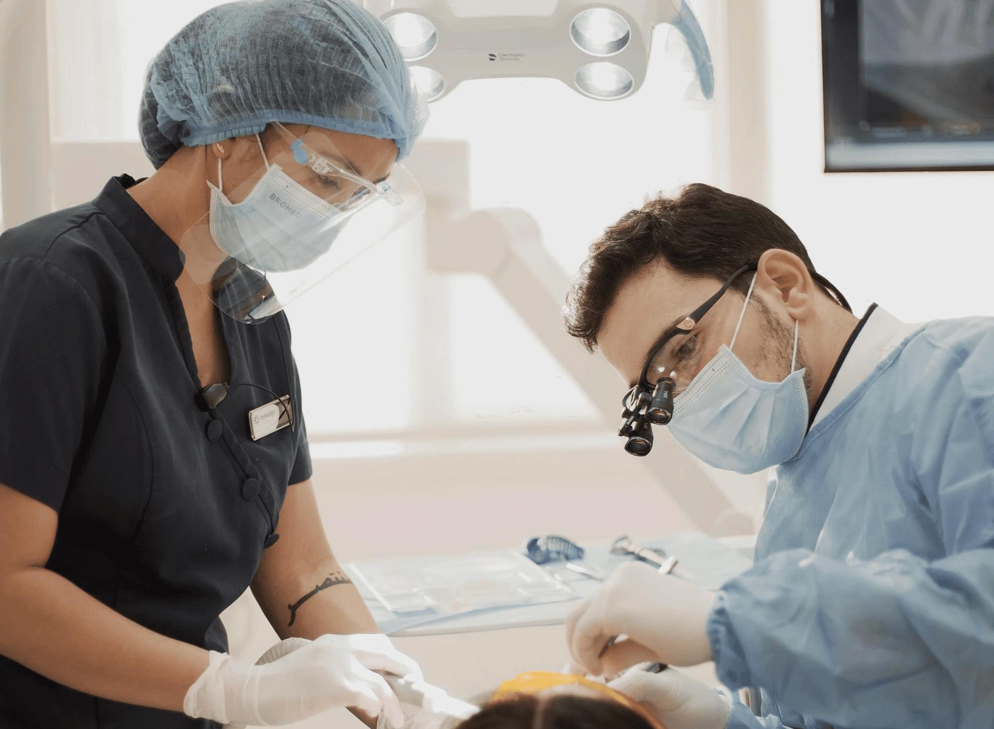 An orthodontist conducting a regular check-up for a client, emphasising consistent care, much like maintaining dog dental hygiene by Invisalign Center