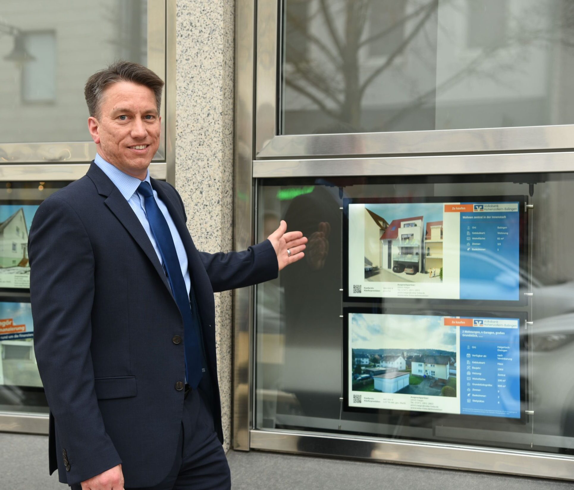 Businessman pointing to property listings in a window.