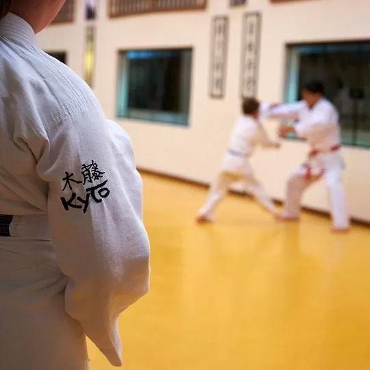 Two adults practicing kickboxing and Muay Thai striking drills at Rai Martial Arts.