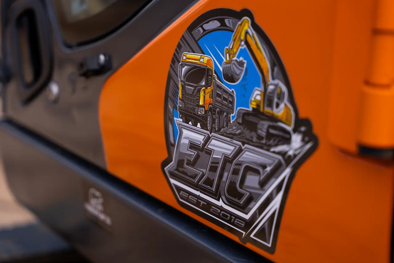 ETC Contracting & Consultants logo on construction equipment, featuring excavator and dump truck graphic