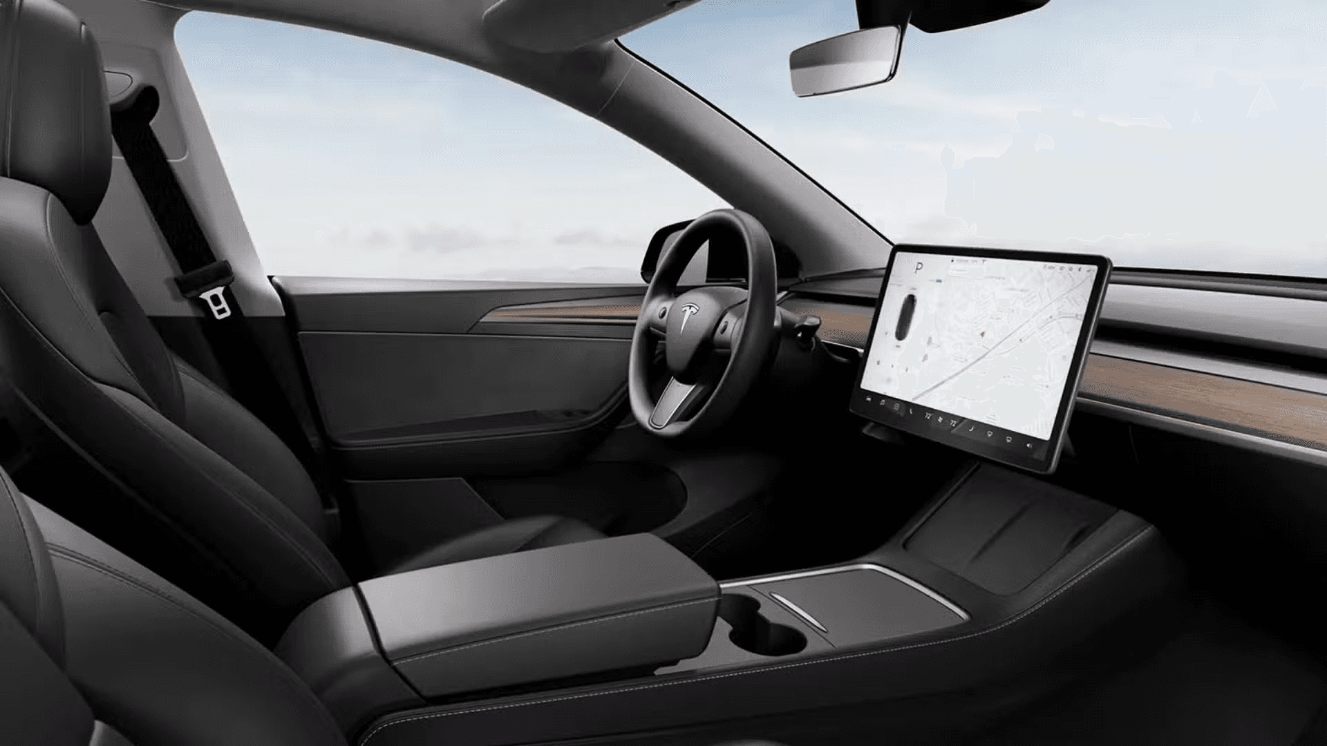 Habitacle de la Tesla Model Y avec grand écran central, design minimaliste et intérieur noir