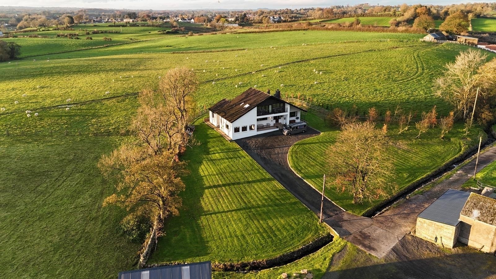A house sitting on top of a lush green hillside