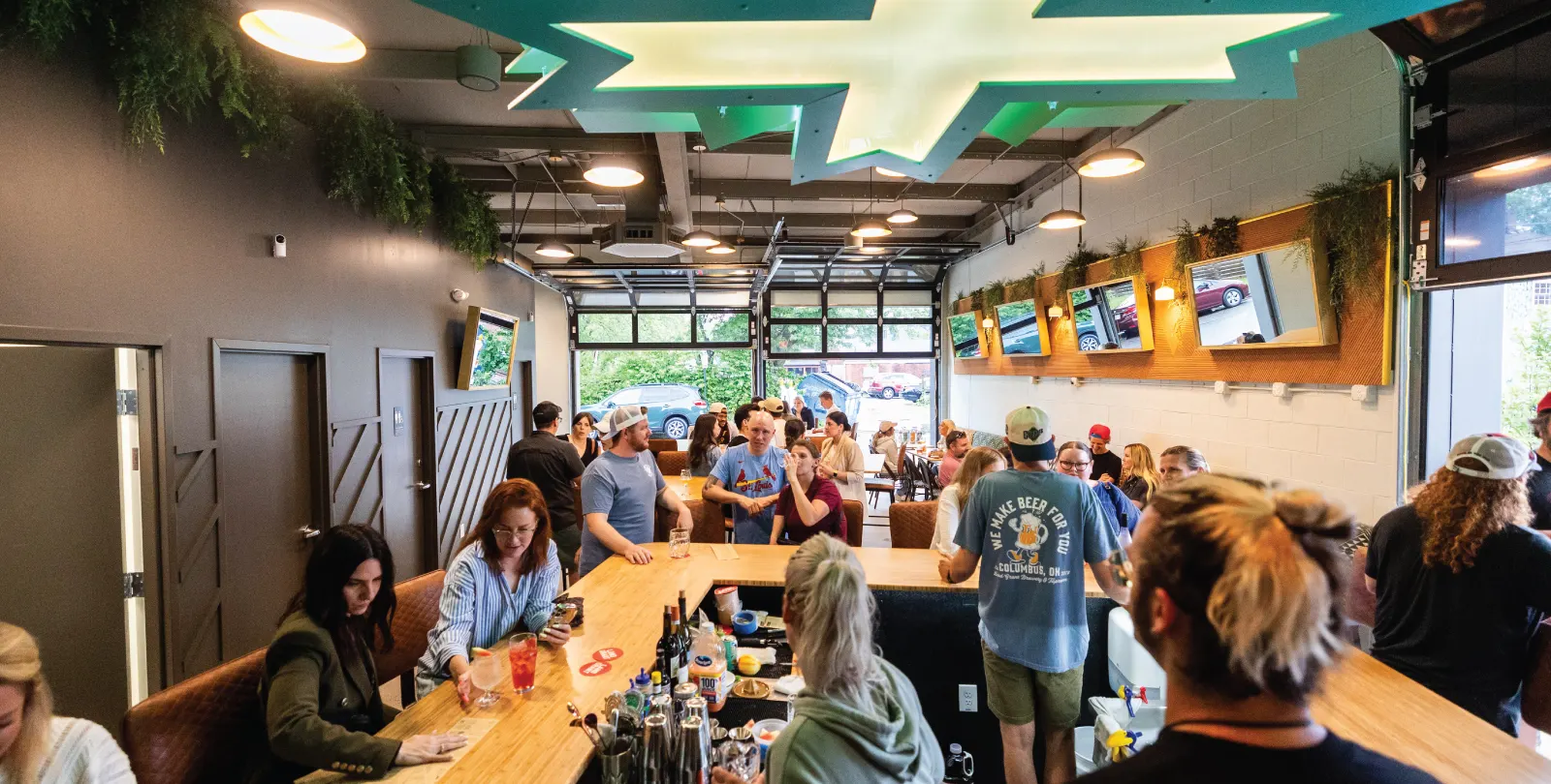 Guests at the long bar inside Land-Grant Extension