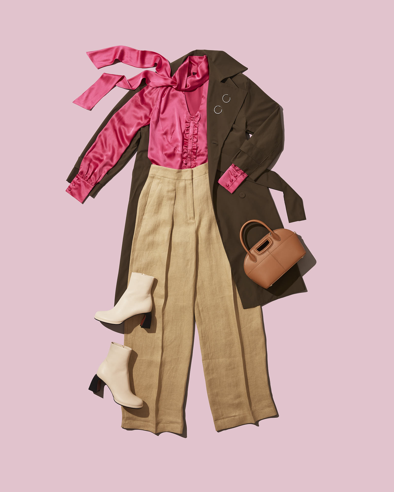 Stylish women's outfit with pink blouse, brown coat, beige pants, ankle boots, and handbag.