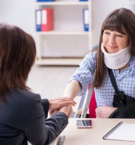 a woman discussing her treatment with a doctor after a car accident - car accident