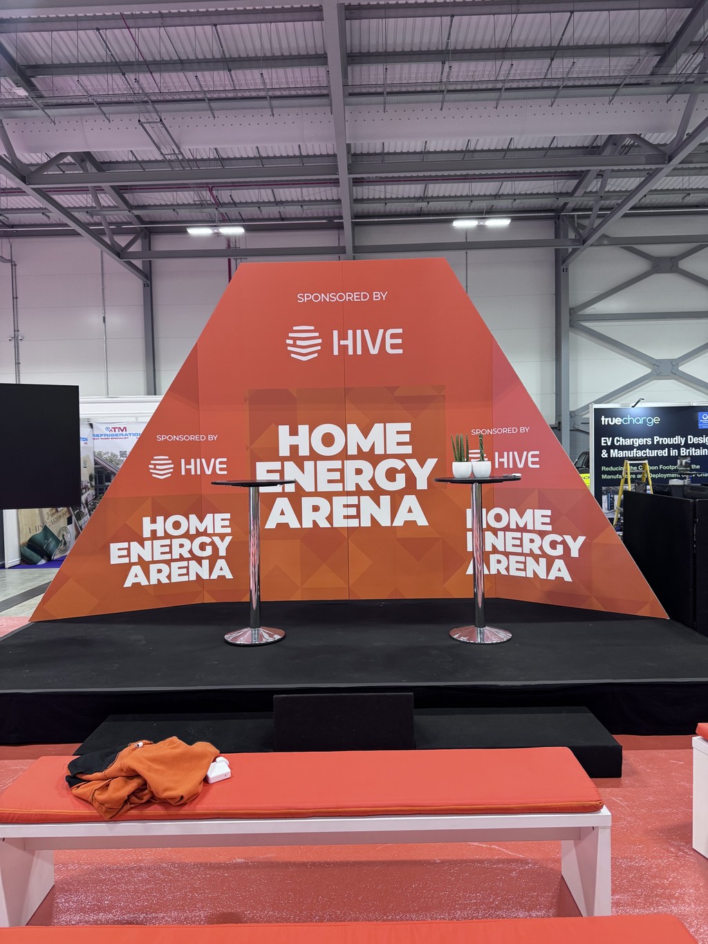 Orange custom-built Home Energy Arena stage set sponsored by Hive at Everything Electric South.