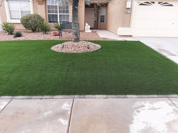 FreshStart Landscaping Vegas desert front yard with artificial turf, decorative rock, and drought tolerant plants