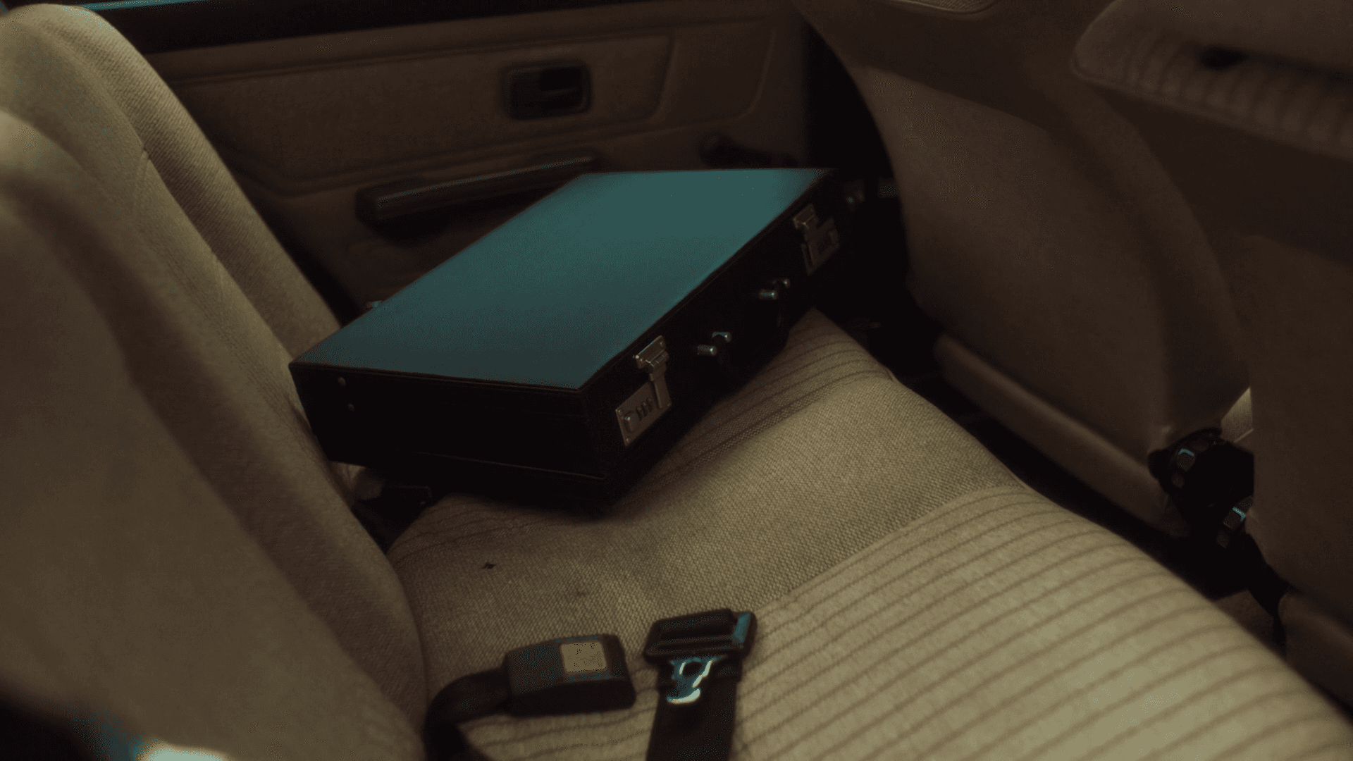 Family picking apples from a tree in an orchard.
