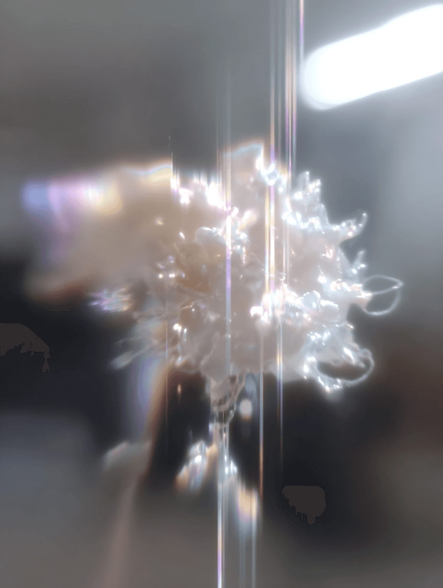 A soft-focus abstract image captures ethereal, cloud-like forms with shimmering, iridescent hues, suggesting a sense of movement and light.