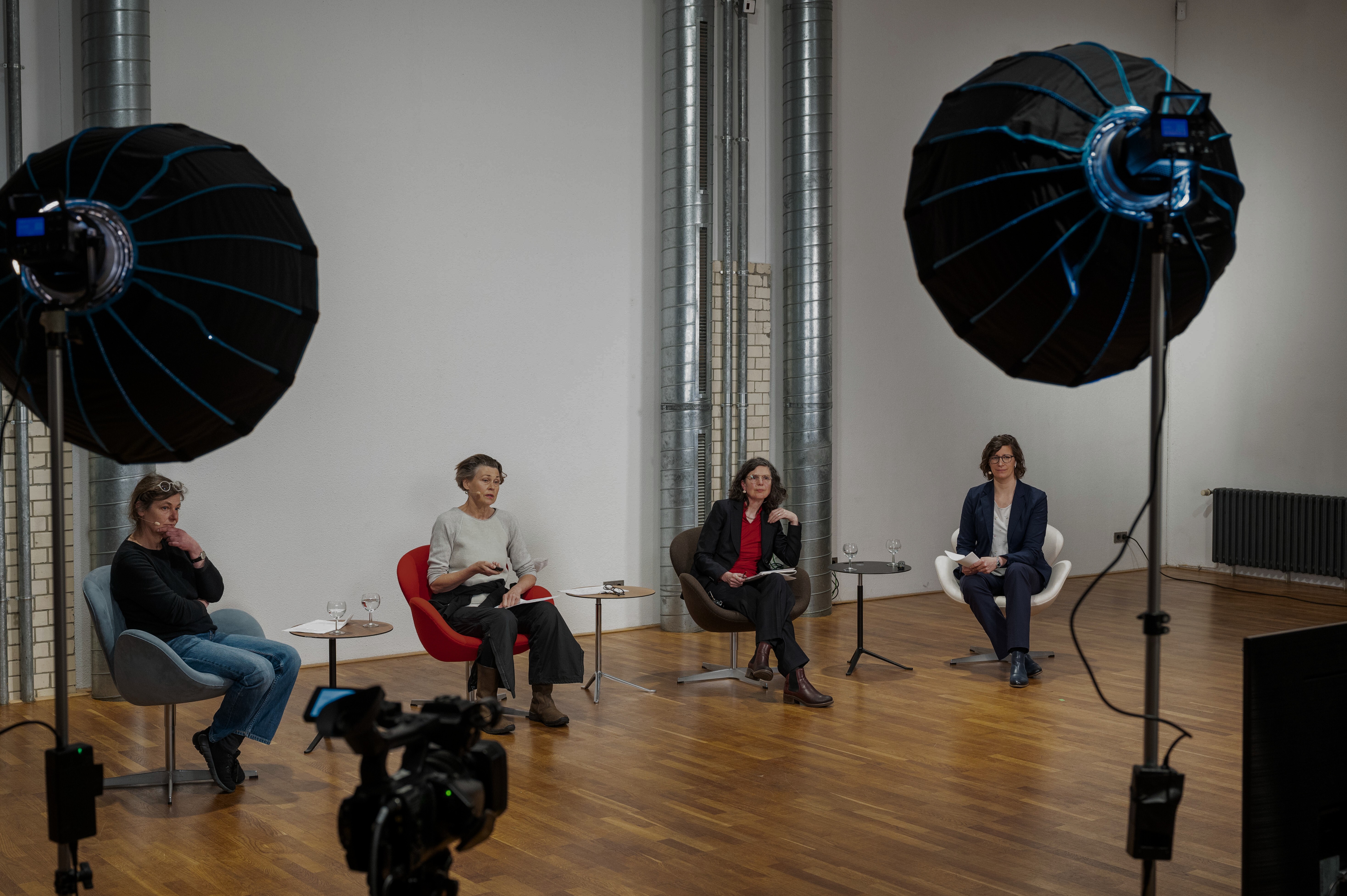 woman in blue tank top standing beside white wall