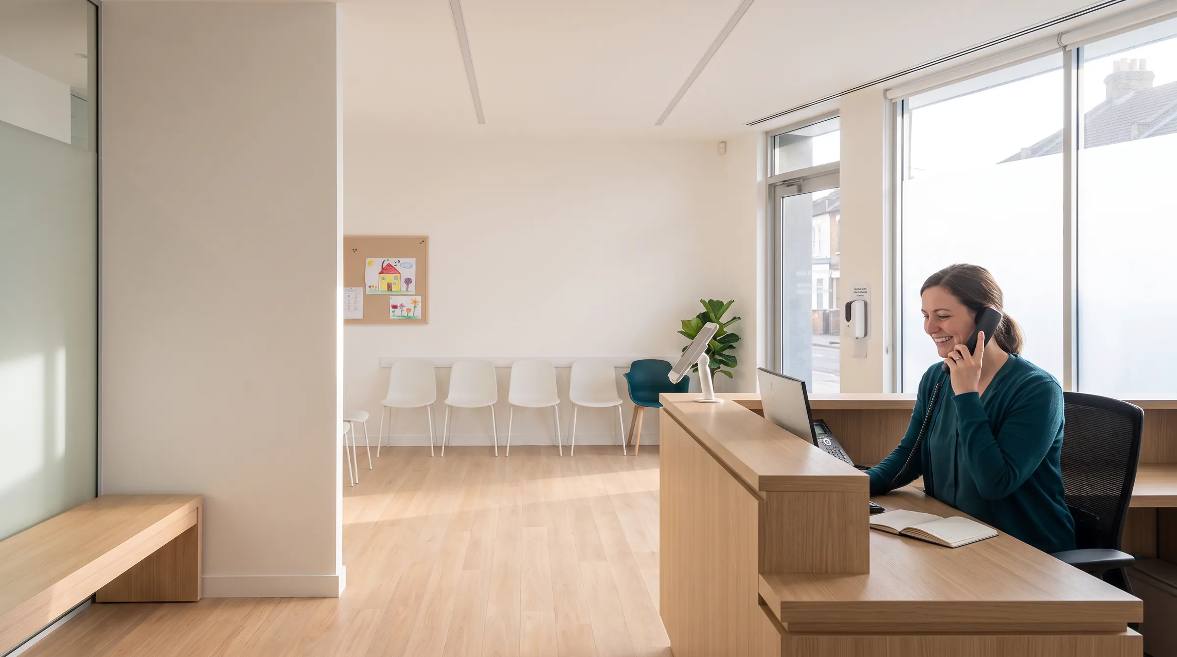 A receptionist answering the phone at the front desk