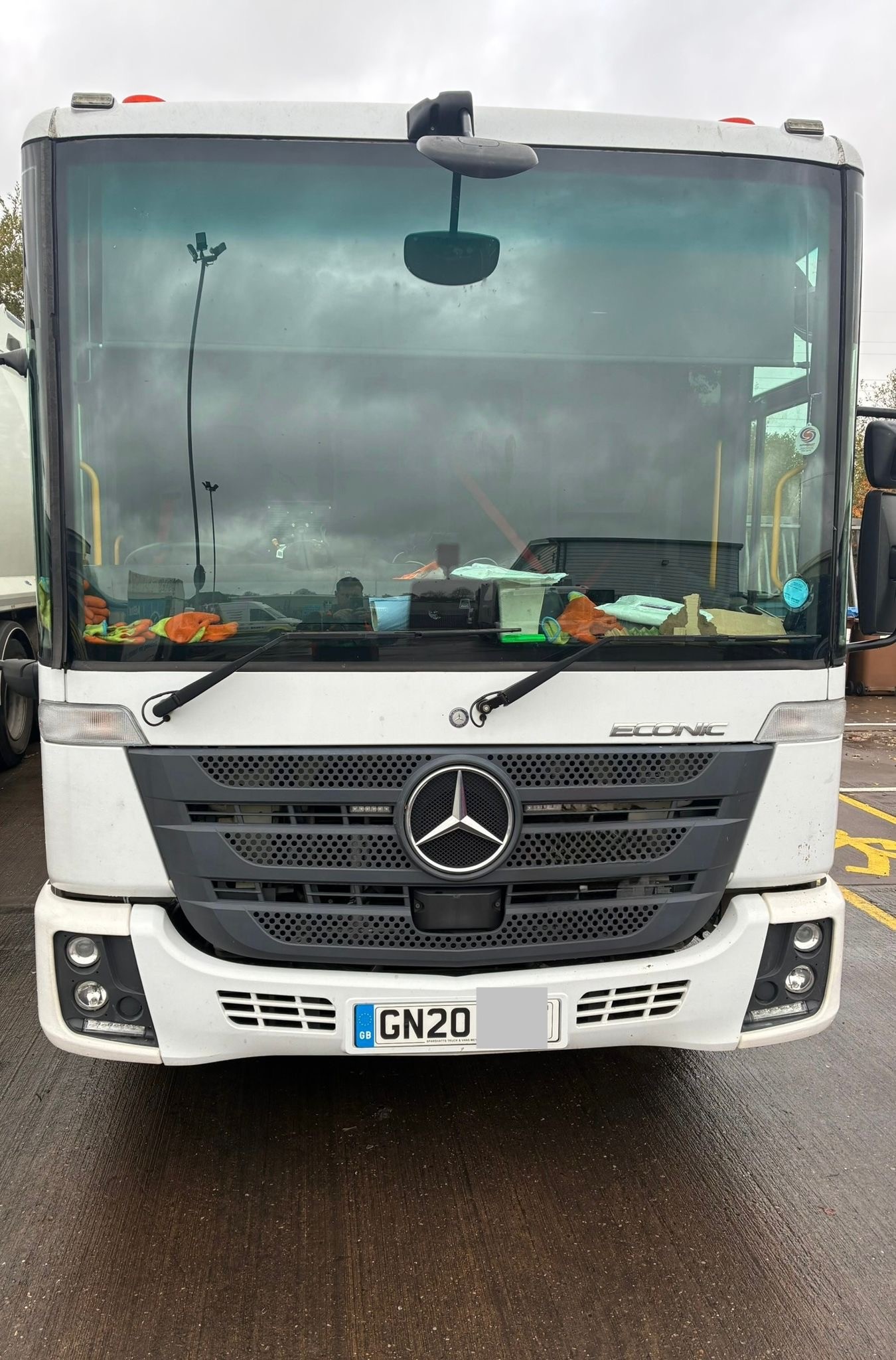 Aerial view of a winding road surrounded by dense green and yellow trees, showcasing nature’s vibrant colors.