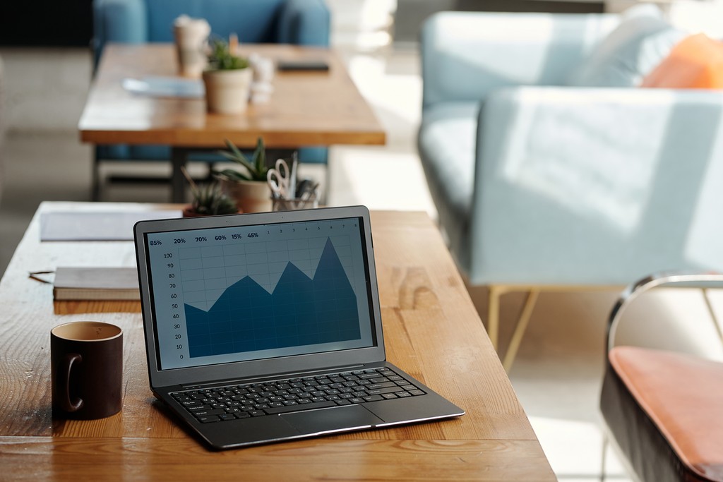 man standing in front of people sitting beside table with laptop computers