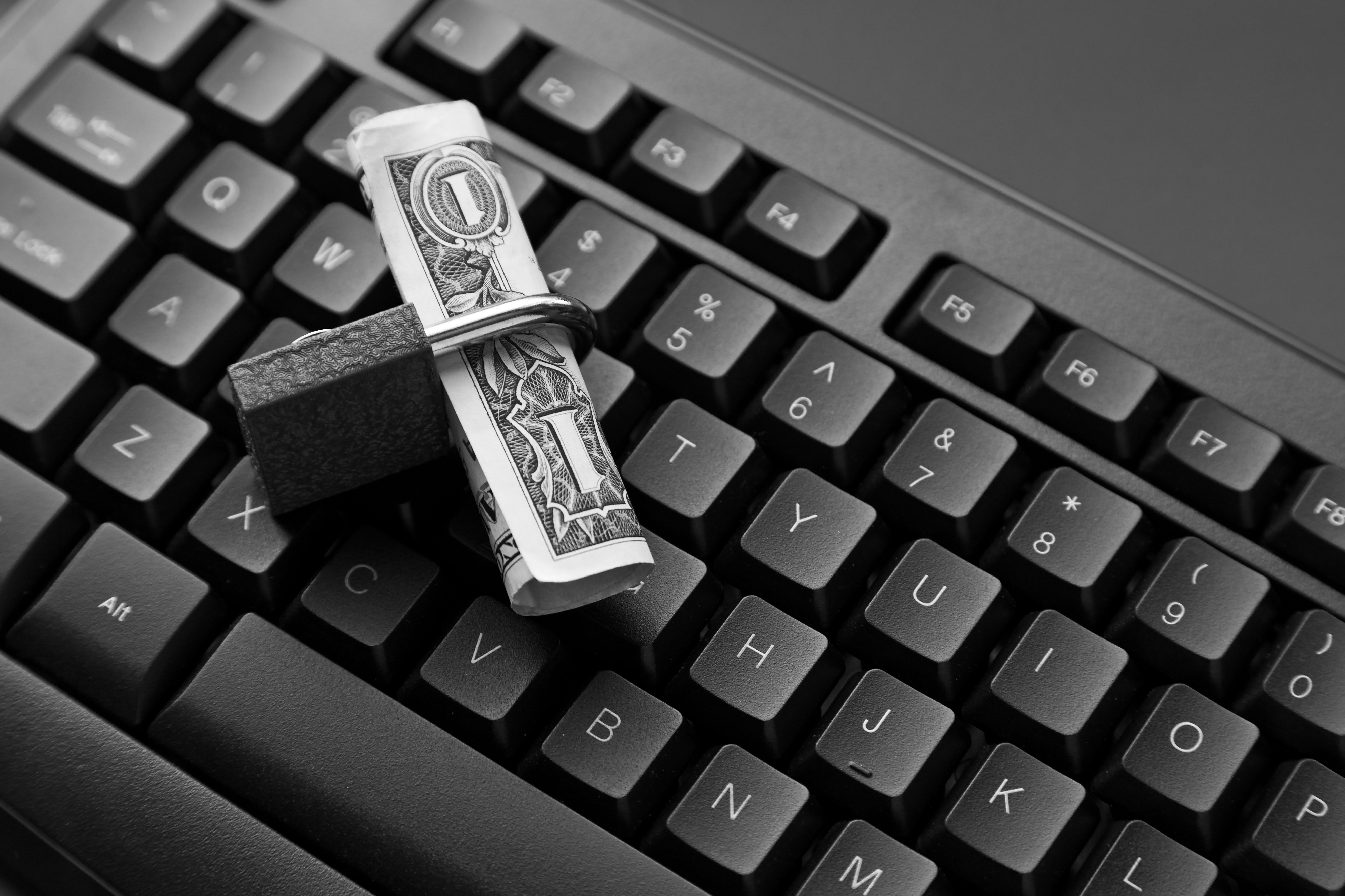 A Keyboard and A padlock with money folded inside. 