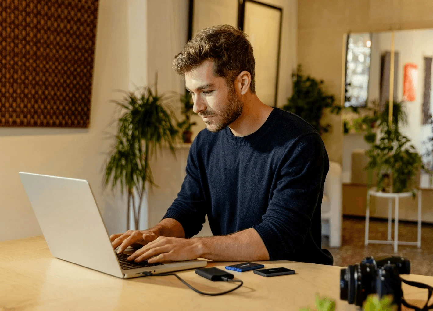 Man working on laptop in modern office, representing professional life balance