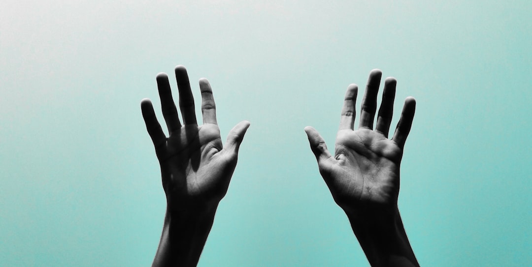hands of a nurse practitioner holding a smartphone, a mobile voice recording app active with clear waveforms, clinical workstation background, bright daylighting