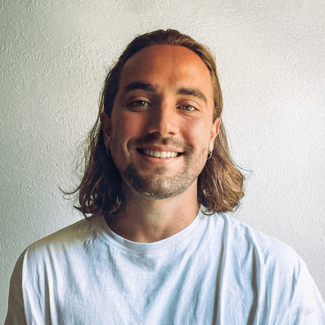 Profile portrait of a man in a white shirt against a light background