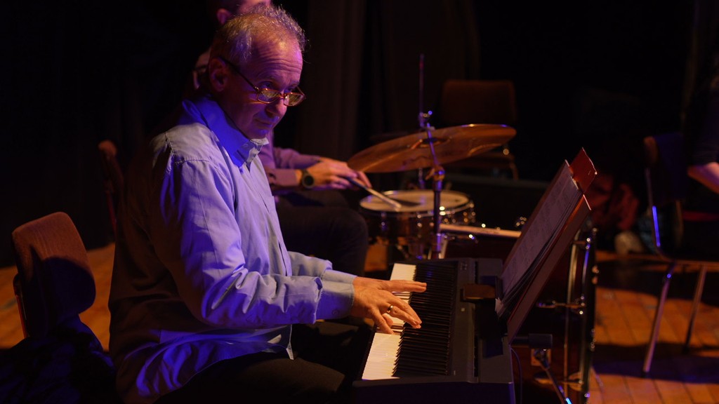 A man sitting behind a drum kit