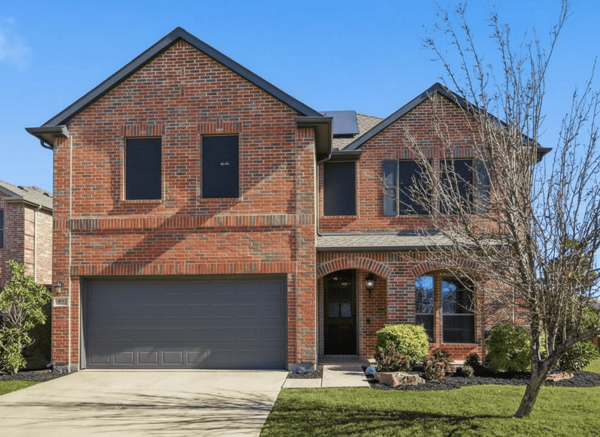 Same brick house with warm gray limewash finish and dark charcoal trim