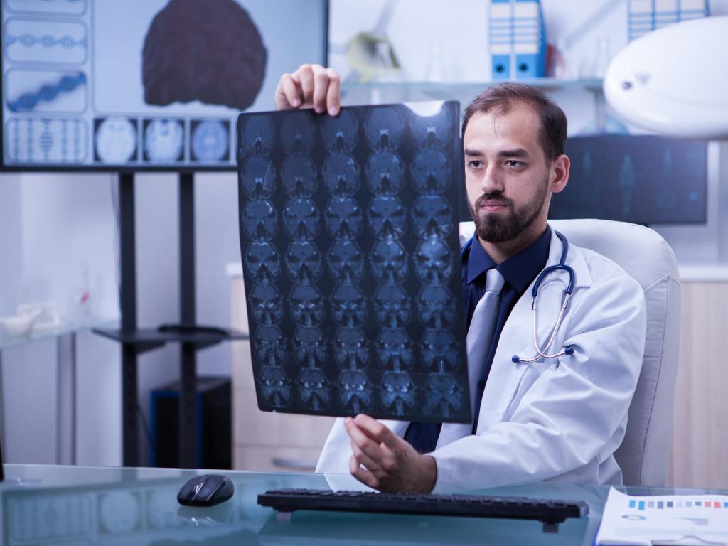 A male doctor examining a MRI scan.