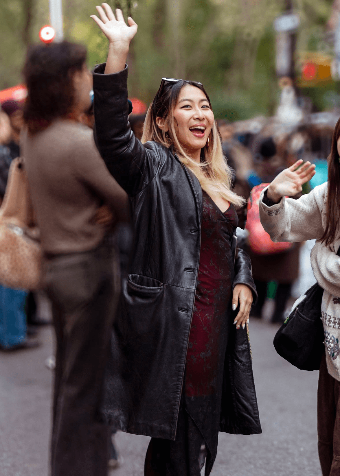 Gina waving at the camera with a big smile on her face