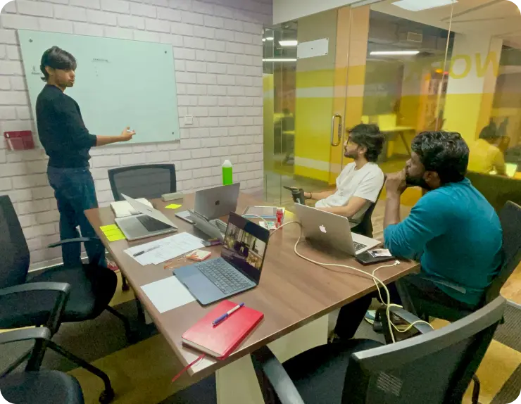 Amaidhi workshop session with team collaborating around table with yellow sticky notes for ideation and planning