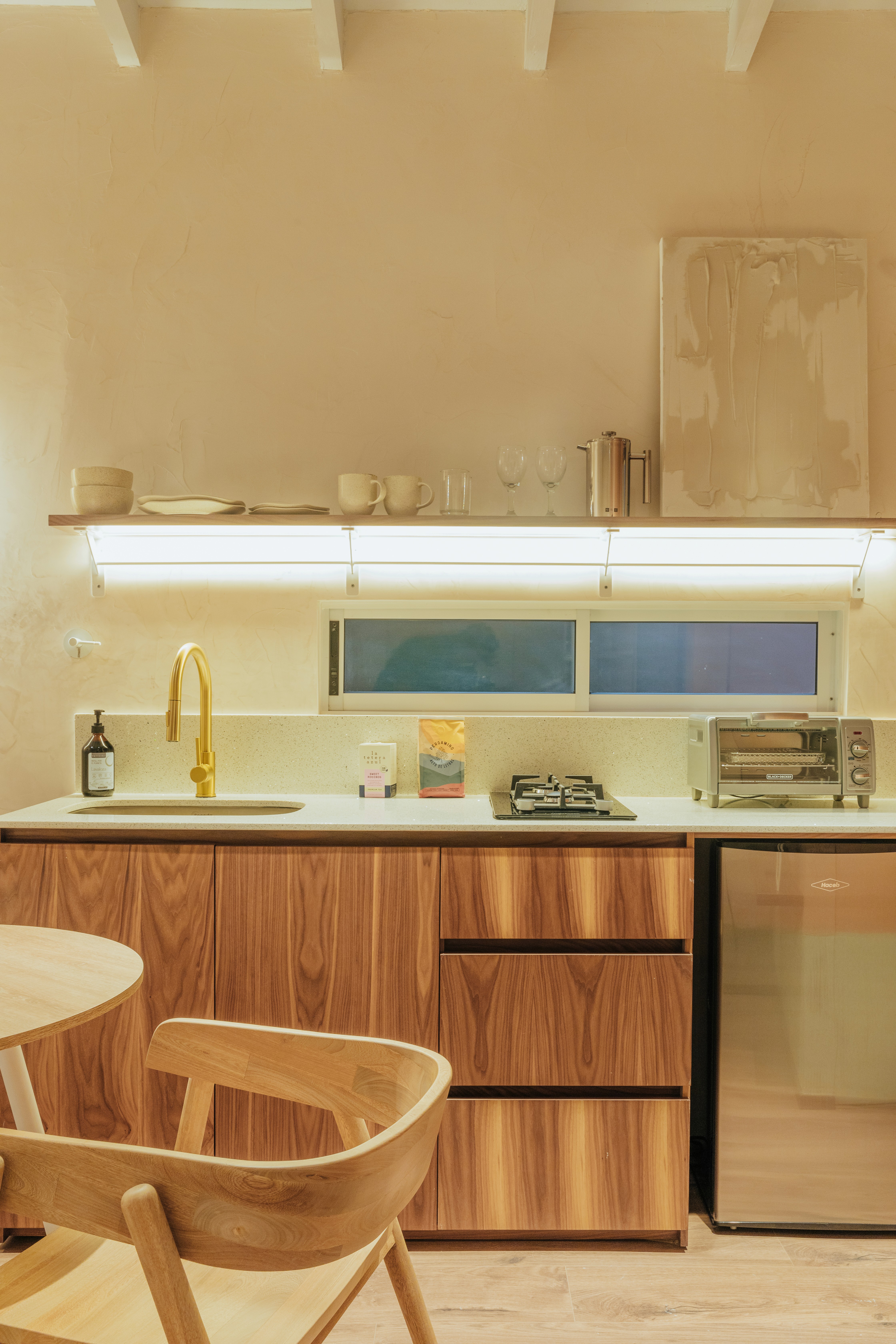 Double-height interior with flowing sculptural forms and warm raking light