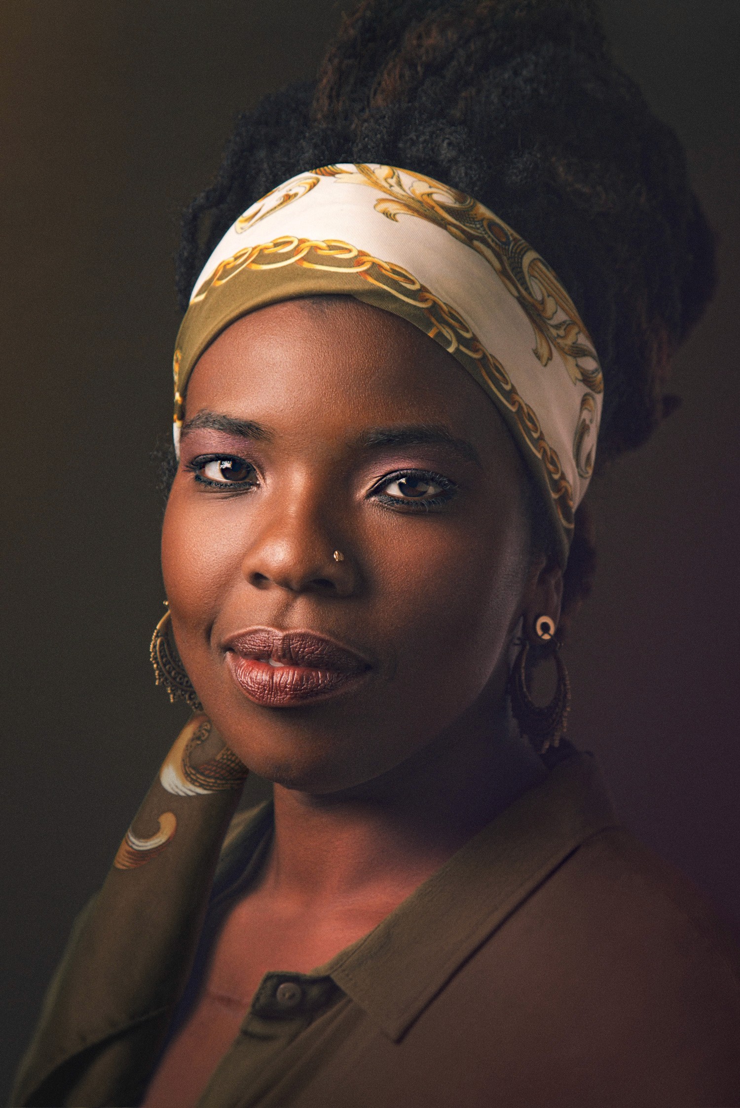 Natural light portrait of South Asian woman smiling with scarf