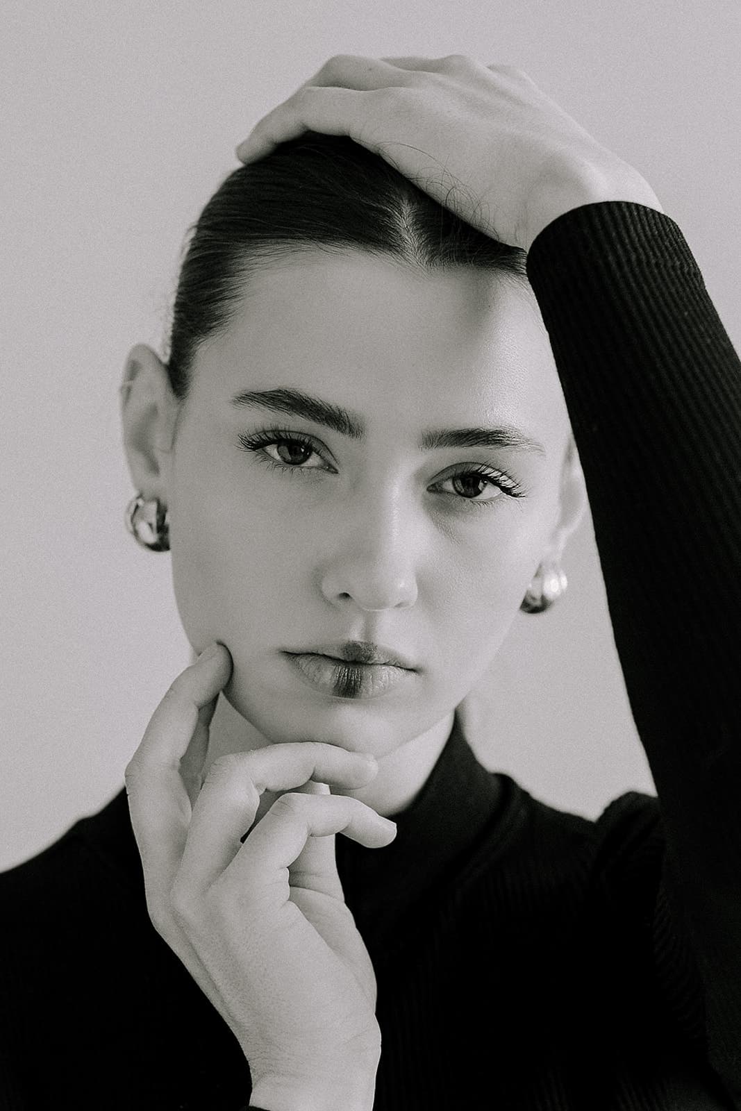 The model stands confidently in a fashionable outfit at Revelator Studio in Shreveport, photographed by Justin Posey, showing the studio’s sleek backdrop and creative energy.