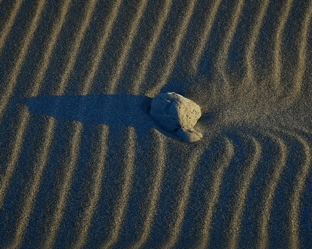 Abstract motion-blurred light patterns in warm gold and green tones against a dark background.