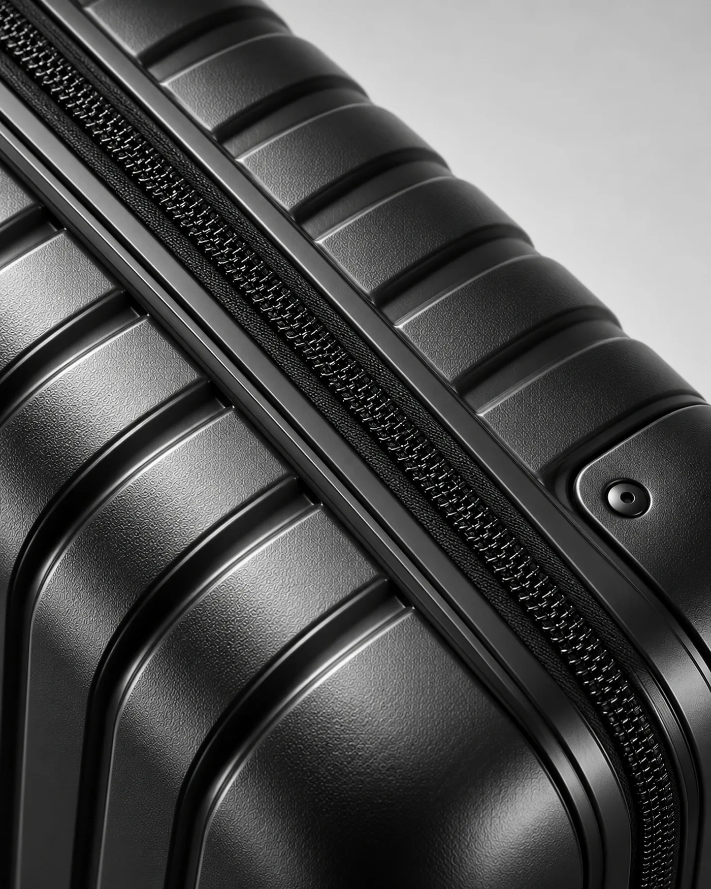 Close-up of the zip and ribs on a black suitcase