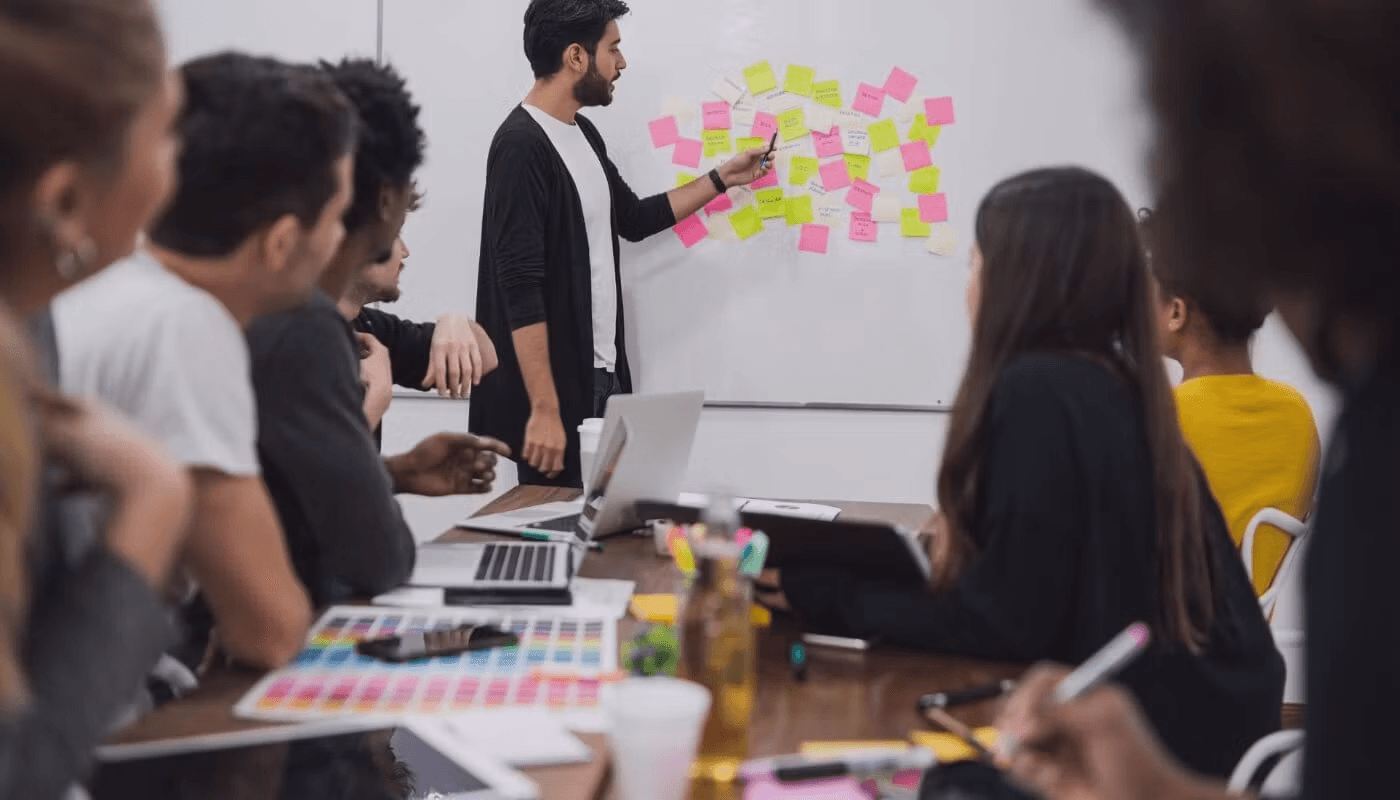 Man presenting to team using sticky notes - Automated Lead Qualification