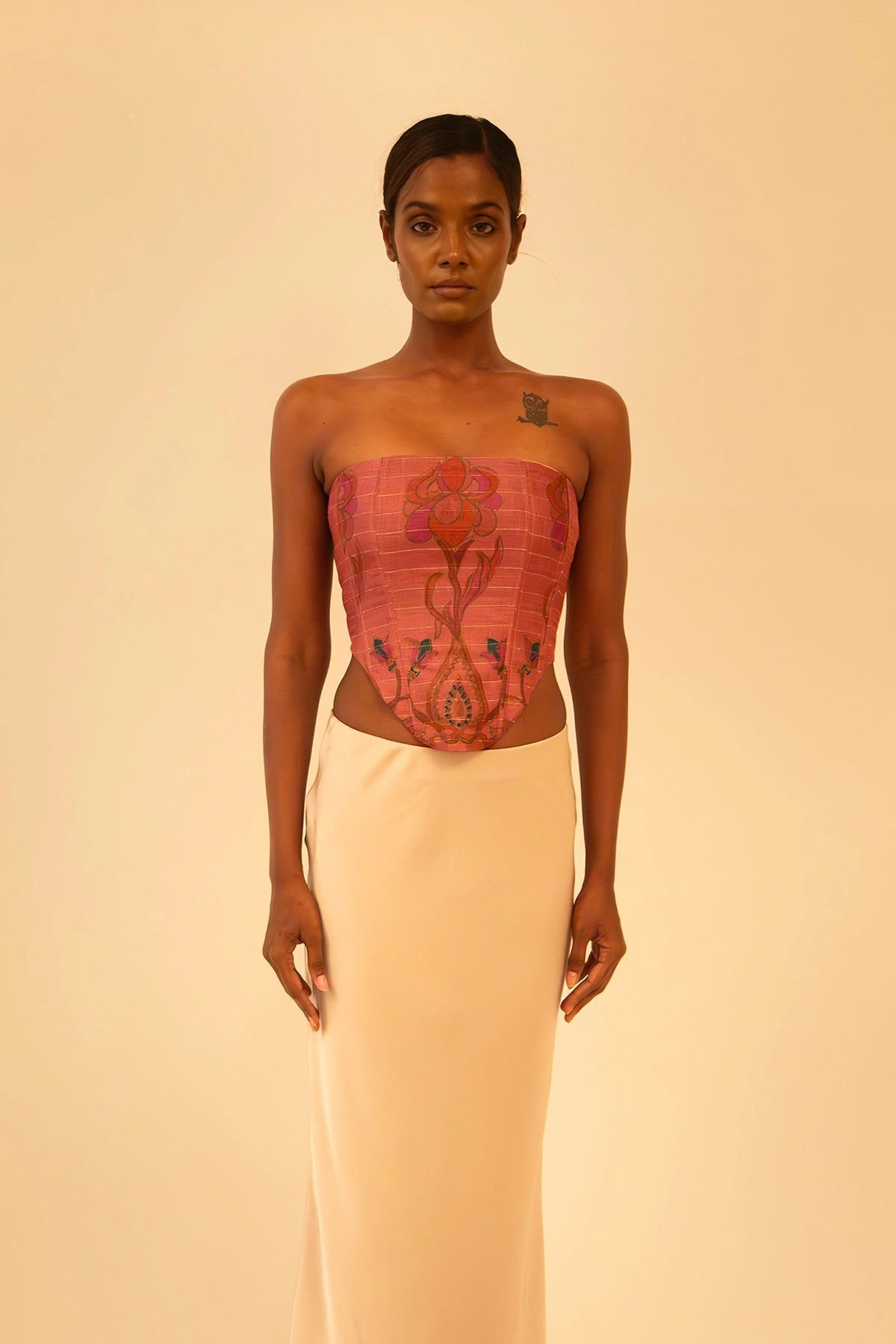 Handcrafted strapless corset made from upcycled vintage silk sari, a structured silhouette, celebrating artisanal craftsmanship and conscious design.