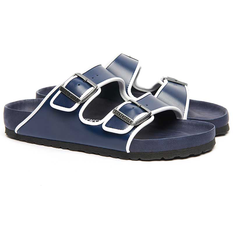 Navy-blue Arizona sandals with white piping — the elevated silhouette rendered in sophisticated tones.