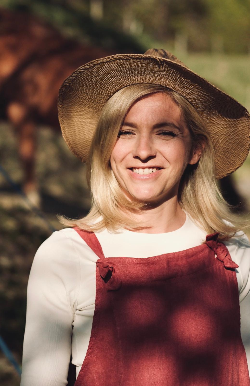 A couple stands outdoors at sunset.