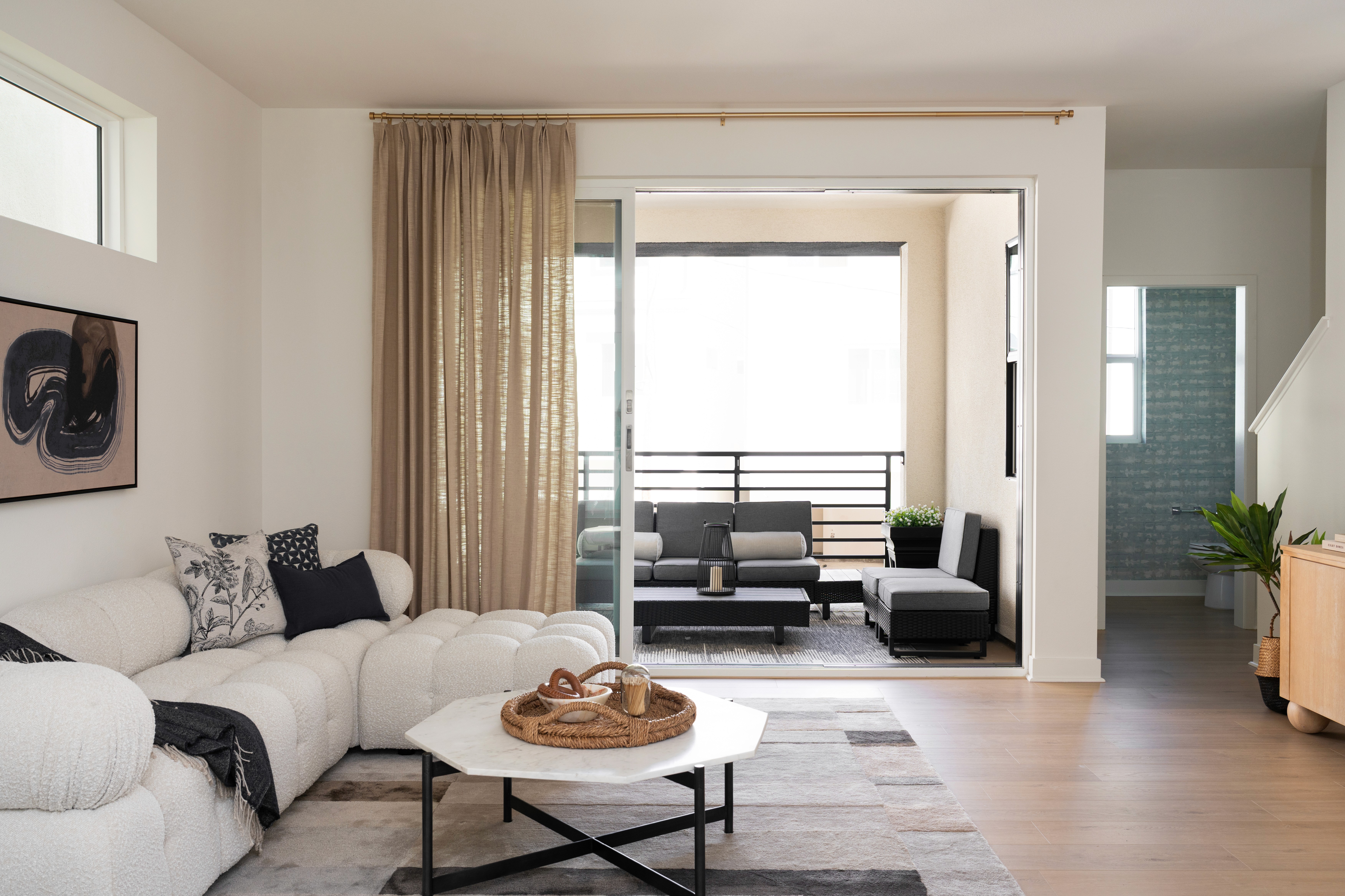 Living room area with view to balcony and outdoor furniture