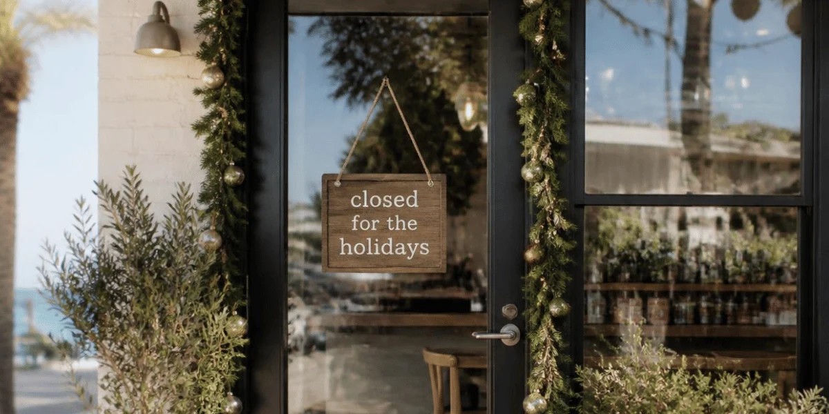 Shopfront at christmas time with sign saying 'closed for the holidays'