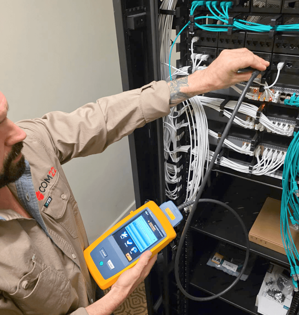 three men laughing while looking in the laptop inside room