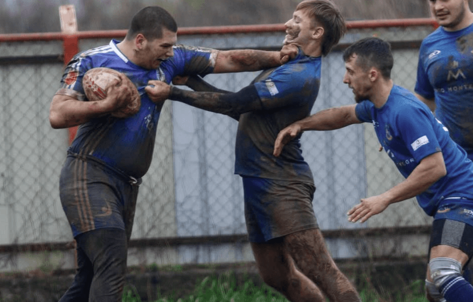 rugby player hands-off another player